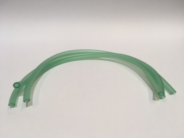 Four green flexible tubes known as "Carburetor Overflow Tubes" are arranged in a gentle curve on a simple background.