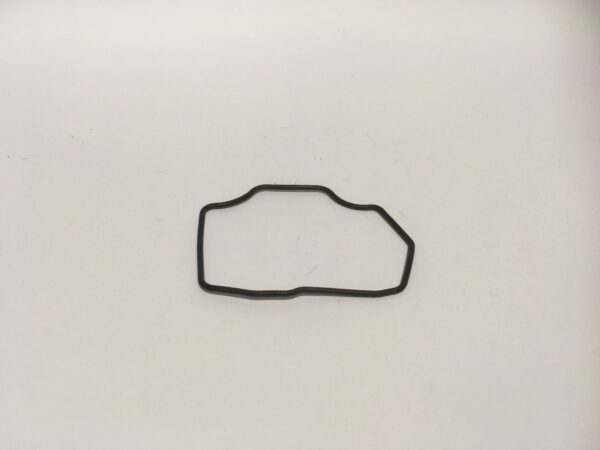 A black rubber gasket with an irregular shape, similar to a float bowl gasket, on a plain white background.
