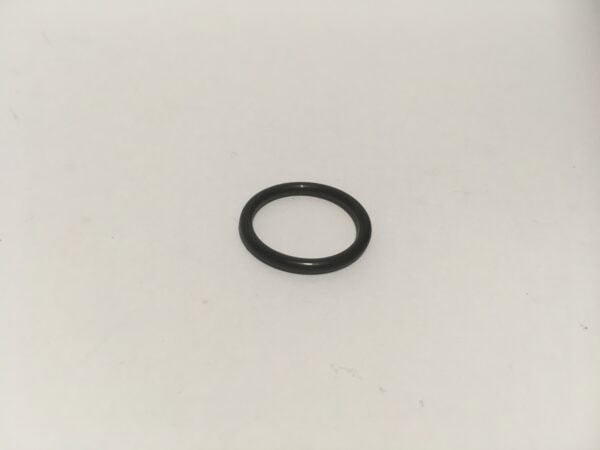 A small black o-ring for an oil cap is placed on a white surface, an essential component ready to seal or hold.