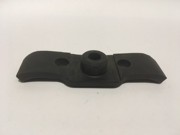 The Fuel Tank Support Rubber is a black metal support with a curved design that includes two holes and a raised circular central section, all on a smooth white background.
