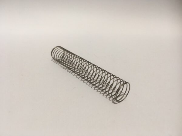 The Second Body Carburetor Diaphragm Spring is a coiled metal spring positioned diagonally on a plain white background.