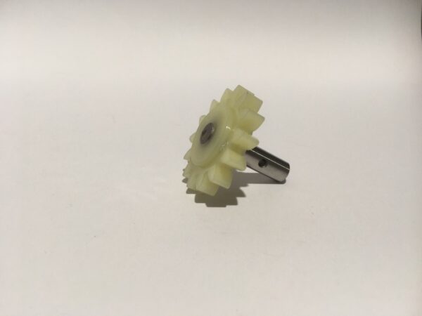 An oil pump sprocket with a metal shaft is positioned on a plain white background.