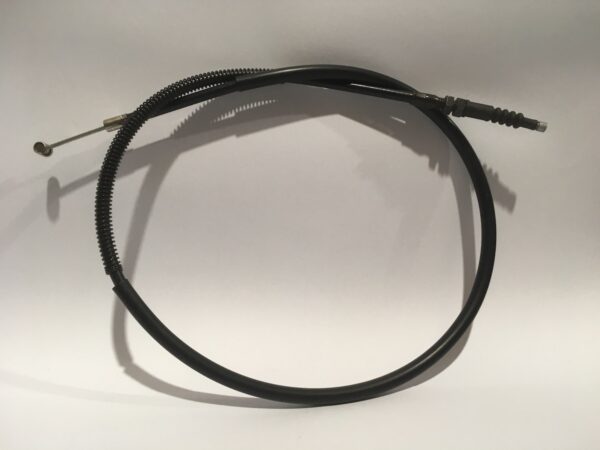 A black mechanical clutch cable with a metal fitting and coiled sections is discreetly coiled in a circle on a plain background.