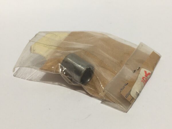 A small cylindrical metal object, possibly a cylinder or head aligner, sealed inside a transparent plastic bag on a white surface.